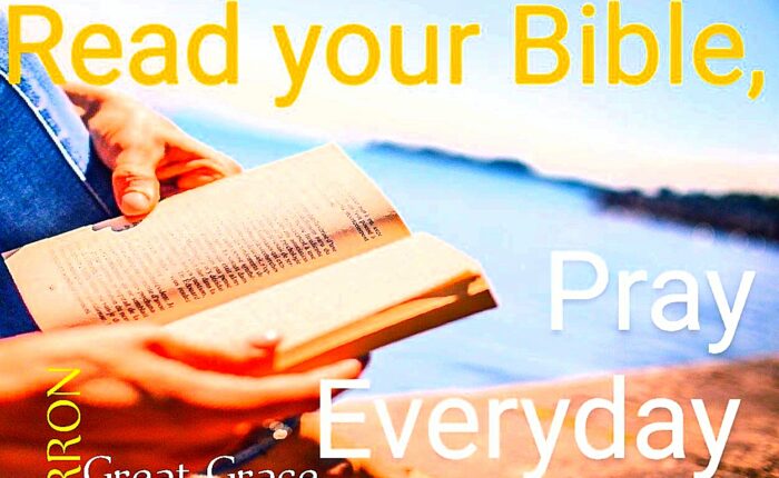 An open Bible is held by someone reading it to build up faith in God
